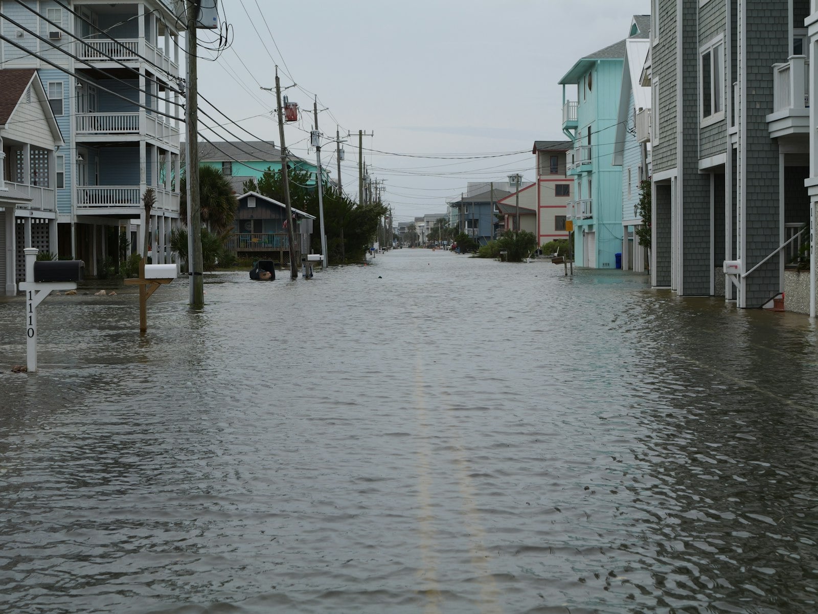 Residential street flooded between houses